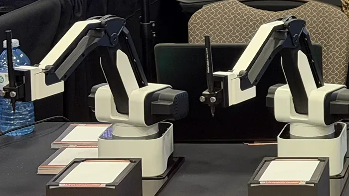 Two Pic Booth Draw Bots set up in the Universus Media Group booth at ACE 2026, Fallsview Casino Resort