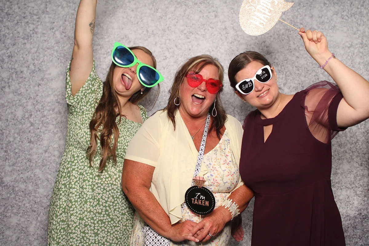 Three wedding guests in novelty sunglasses mid-cheer at the Magic Mirror, Niagara-on-the-Lake wedding reception