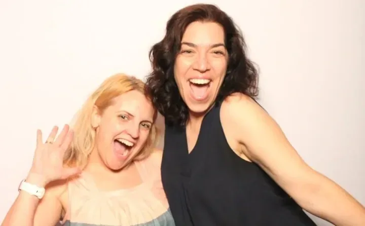 Two festival guests laughing on the magazine-cover set at the Oakville Festivals of Film & Art
