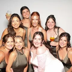 Bridesmaids in sage dresses laughing together