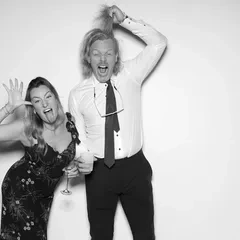 Two guests pulling faces in black and white