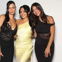 Three friends in black and yellow dresses