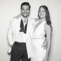 A couple in a white suit and white dress